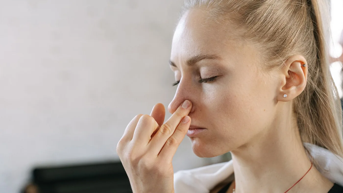 Caucasian woman practicing nadi shodhana pranayama for mindfulness and wellness indoors.
